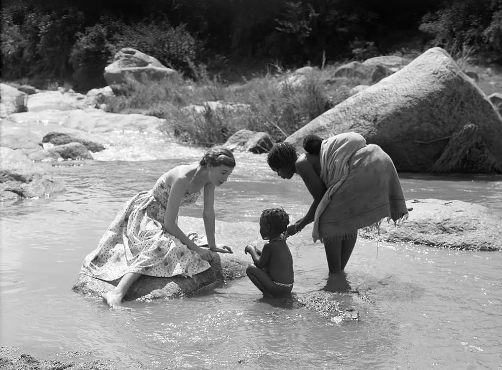 Wenda Parkinson Wearing A Dress By Susan Small And Is Photographed With A Mother And Her Children For Vogue, 1951