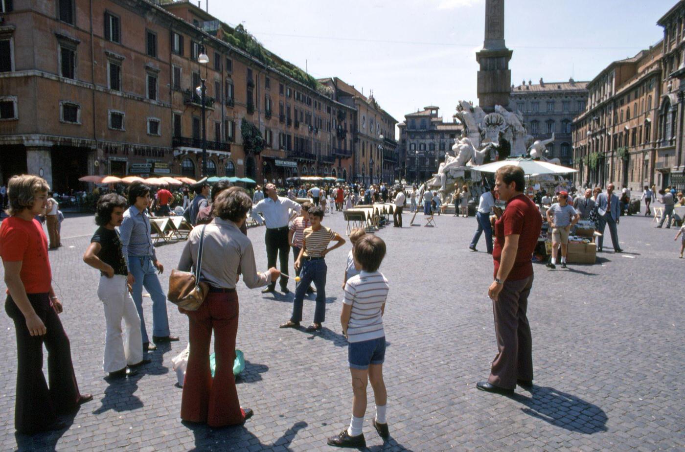 Group Of People In Bell Bottoms At Piazza Navona In Rome, Italy, July 1971