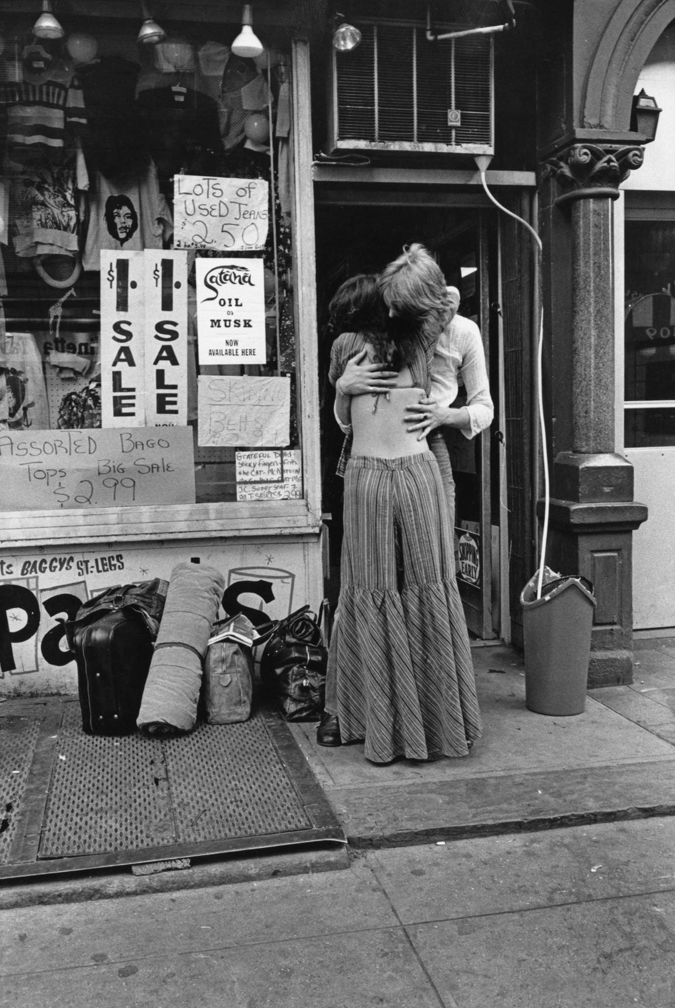Hippie Couple In Bell-Bottoms Embracing Outside A Second-Hand Clothing Shop In St. Mark'S Place, New York City, 1972