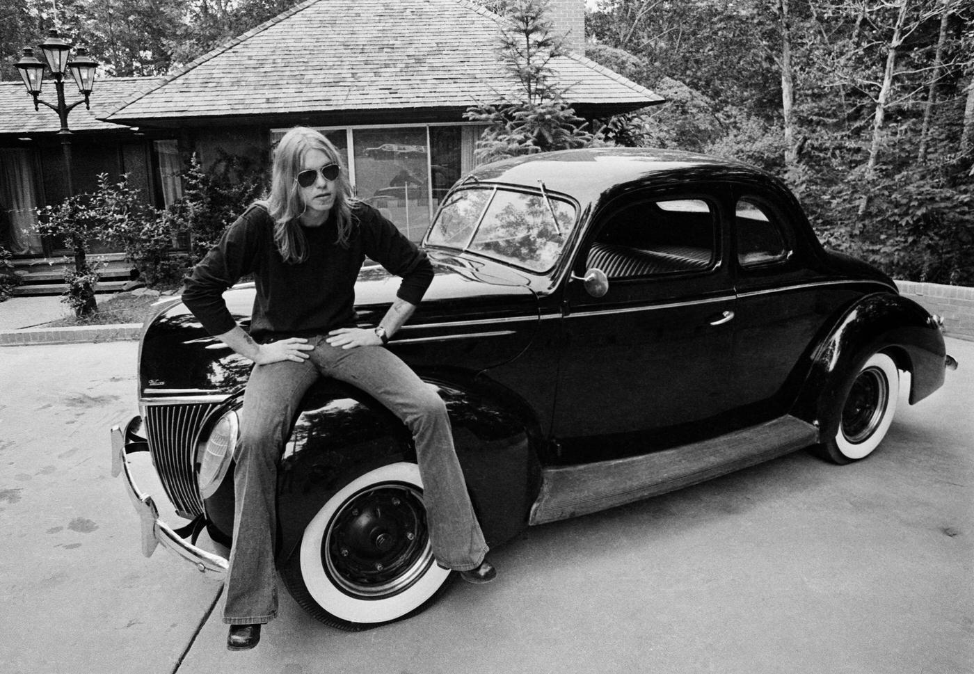 Gregg Allman With His Ford Deluxe In Macon, Georgia, Wearing Bell-Bottoms, 1974