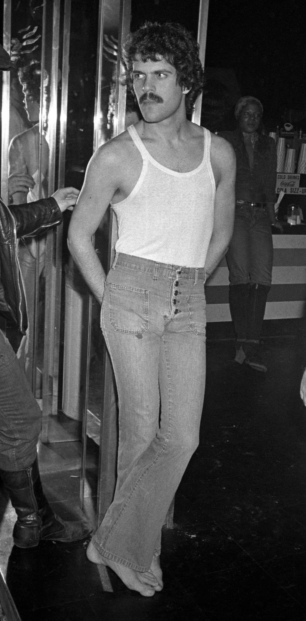 A Man With A Moustache Wearing Jeans And A Tank Top At The Continental Club Bath House In New York, 1970S