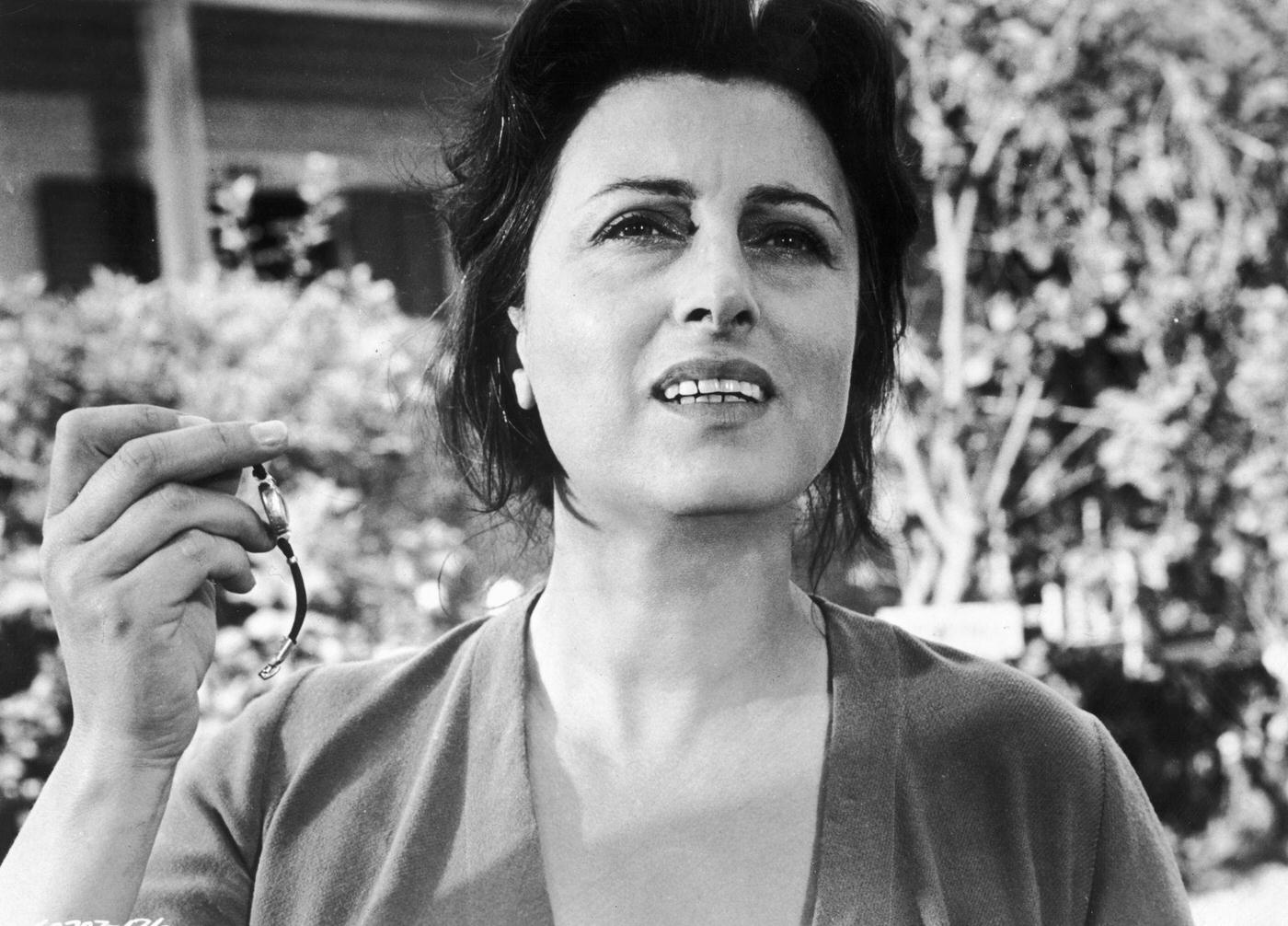 Anna Magnani Holding Up A Wristwatch In A Still From The Film 'The Rose Tattoo,' Directed By Daniel Mann, 1955.