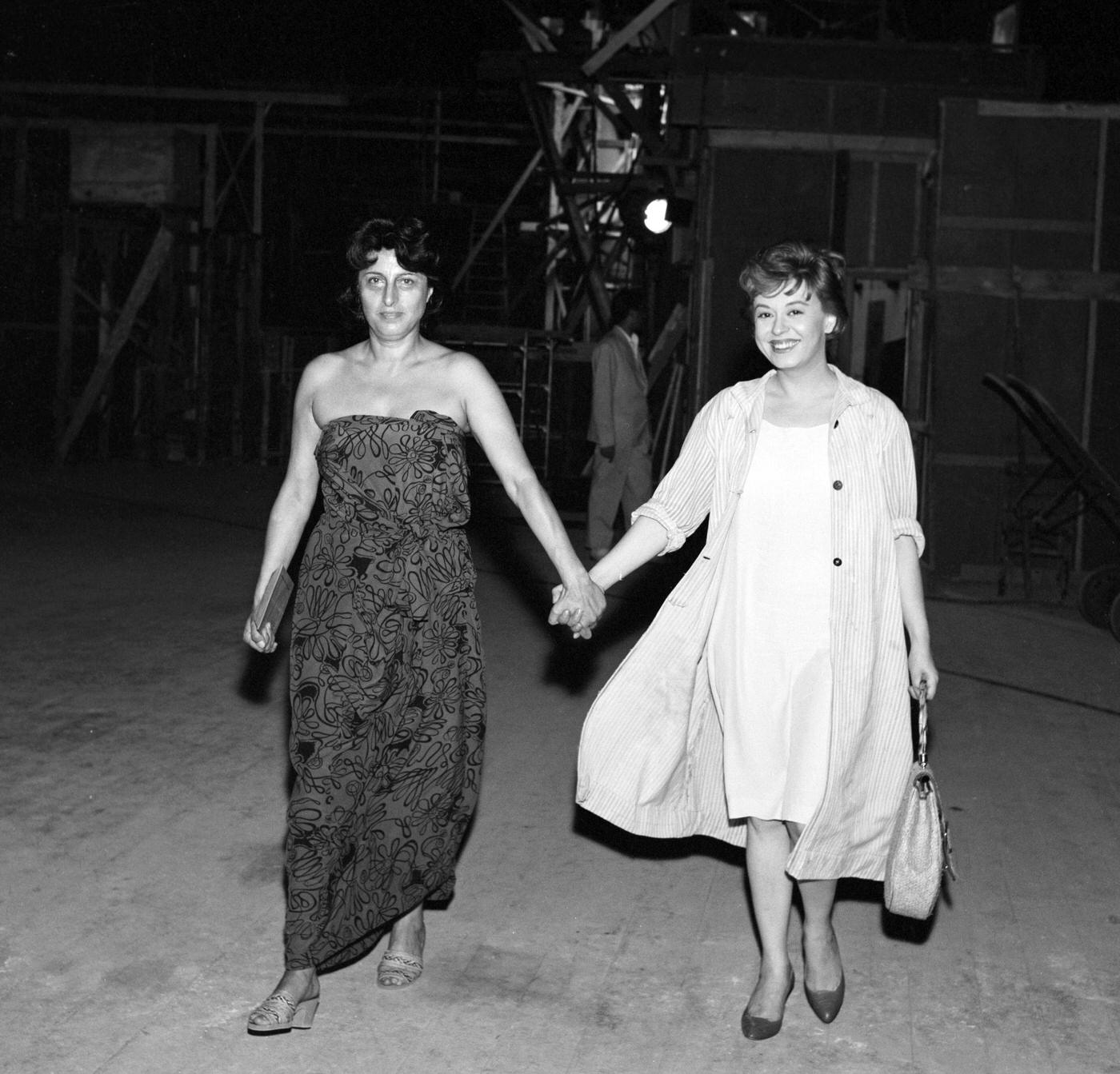 Es Anna Magnani And Giulietta Masina Are Pictured Walking Hand In Hand On The Set Of &Amp;Quot;Behind Closed Shutters&Amp;Quot; At Cinecittà Studios During A Break, 1958