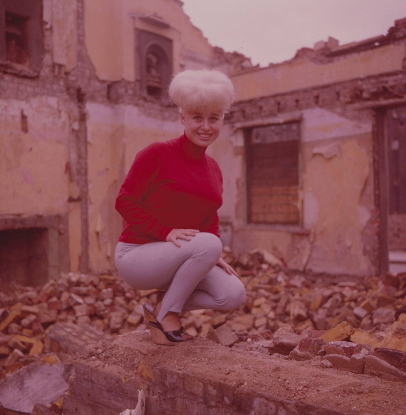Barbara Windsor In A Red Jumper Beside A Demolished Building In London, 1964.