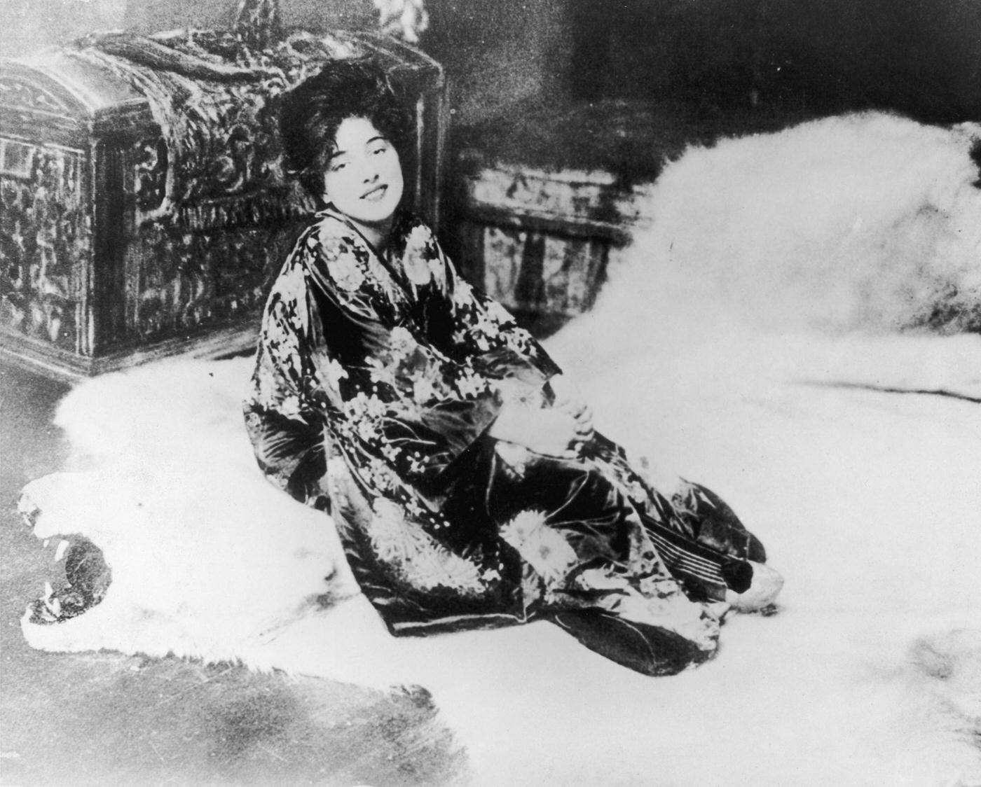 Portrait Of American Actor And Model Evelyn Nesbit Posing On A Bearskin Rug In A Kimono, 1902.