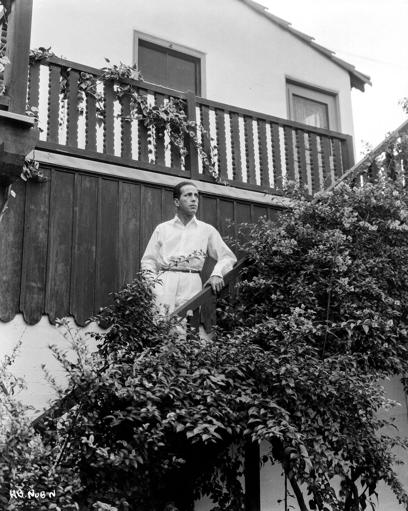 Humphrey Bogart Standing On The Steps Of A House, For Warner Bros Studios, 1938.
