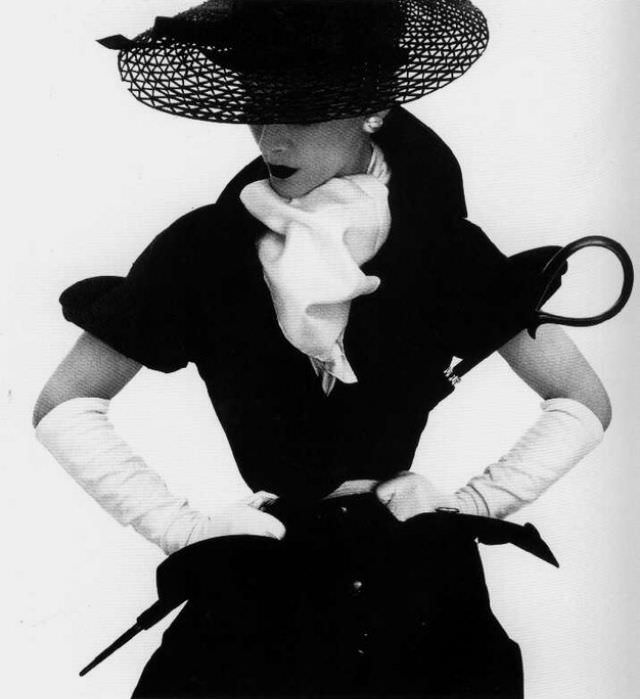 Model Lisa Fonssagrives-Penn Wearing A Black Dress With A White Scarf, Gloves, Wide-Brimmed Hat, And Belt, Holding Umbrella