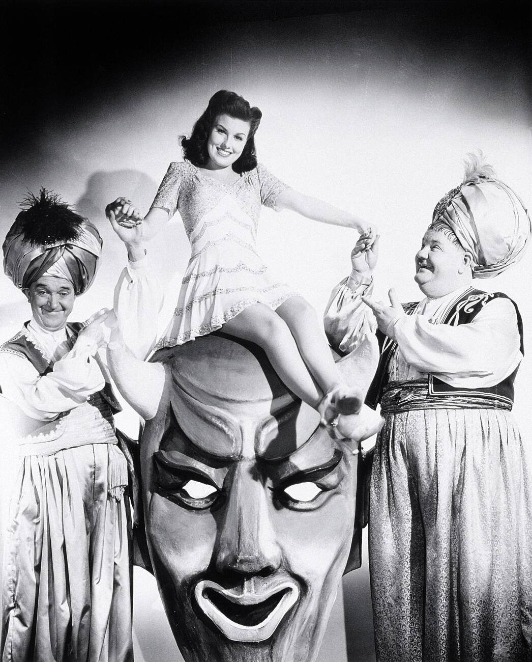 Stan Laurel, Sheila Ryan, And Oliver Hardy In The 1942 Film 'A-Haunting We Will Go'.