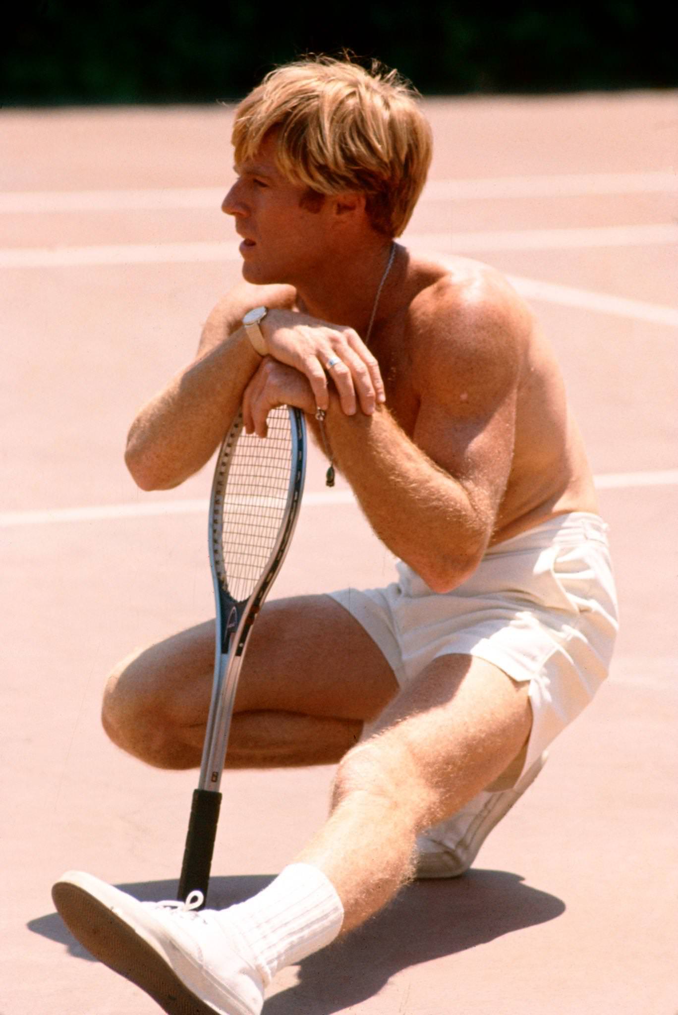 Robert Redford Sitting On A Tennis Court In A Scene From 'The Way We Were' (Directed By Sydney Pollack), 1972.