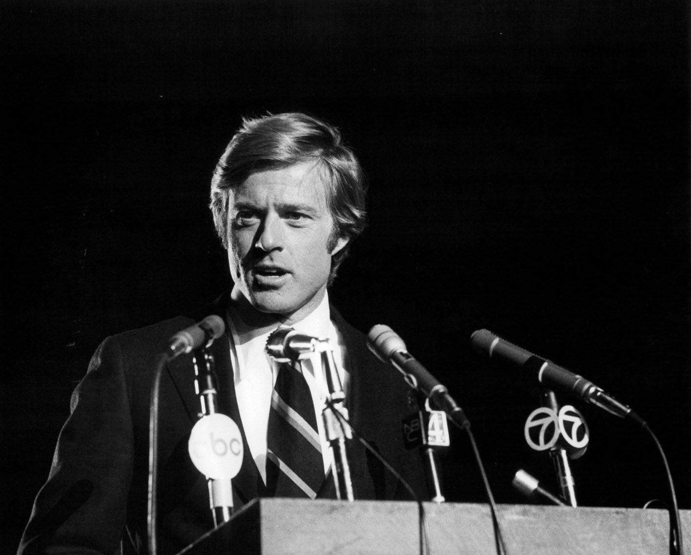 Robert Redford Standing Behind Microphones In A Scene From 'The Candidate', 1972.