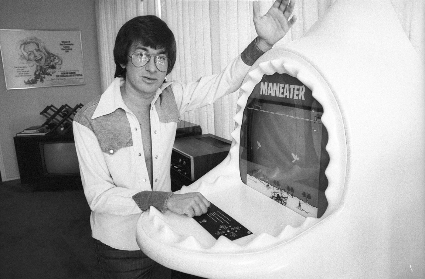Steven Spielberg Poses For A Photo With A 'Maneater' Arcade Game At His Universal Studios Office, December 1975.
