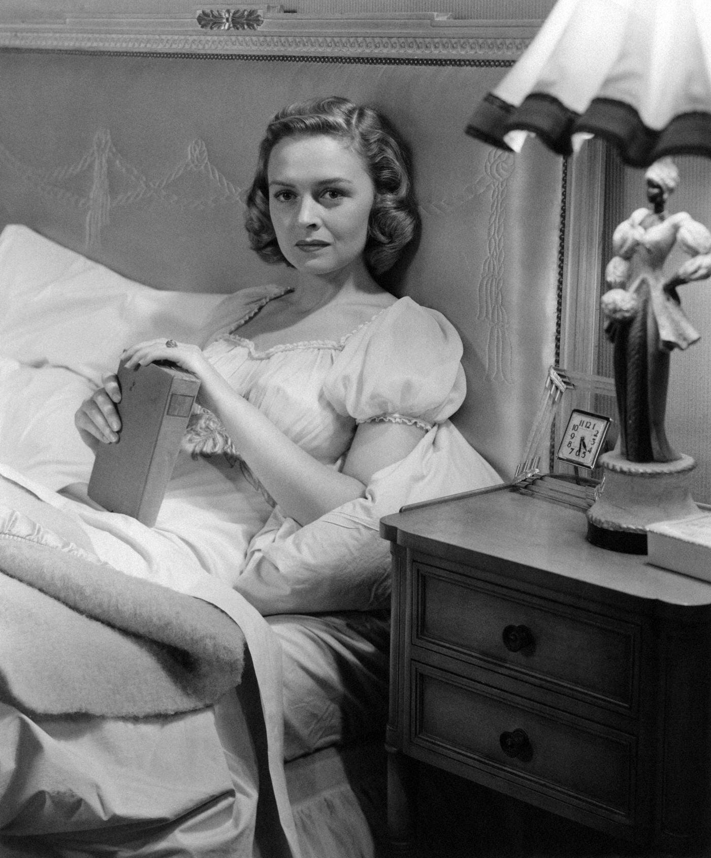 Donna Reed Holds A Book While Lying In Bed In A Scene From The 1948 Film &Amp;Quot;Beyond Glory.&Amp;Quot;