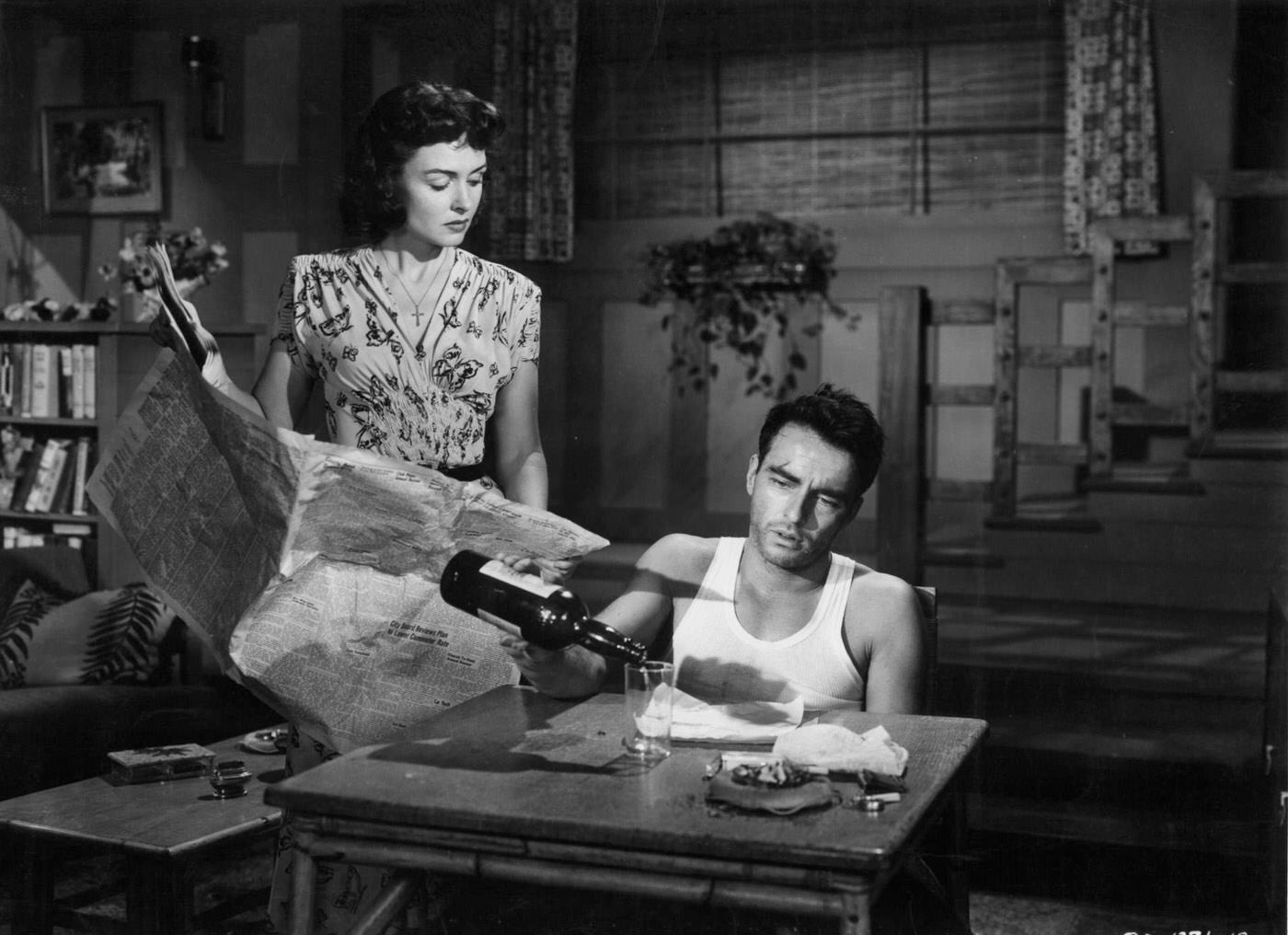 Donna Reed Watches As Montgomery Clift Pours A Drink In A Scene From 'From Here To Eternity', 1953.
