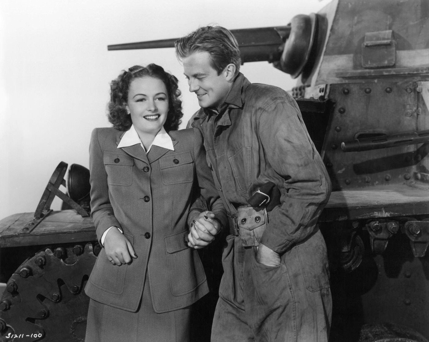 Donna Reed And William Lundigan Hold Hands Next To An Army Tank In A Scene From The 1942 Film &Amp;Quot;The Bugle Sounds.&Amp;Quot;