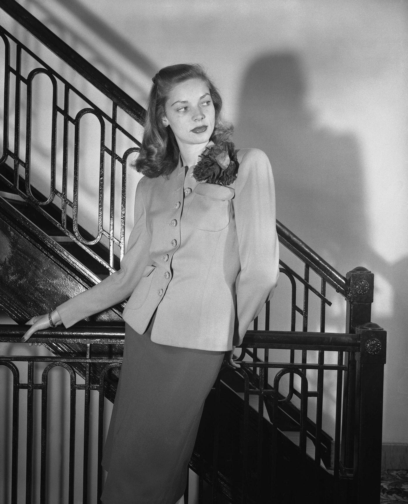 Lauren Bacall Models A Two-Piece Suit By Jo Copland, Consisting Of A Beige Woolen Jacket And Luggage Tan Skirt, 1946
