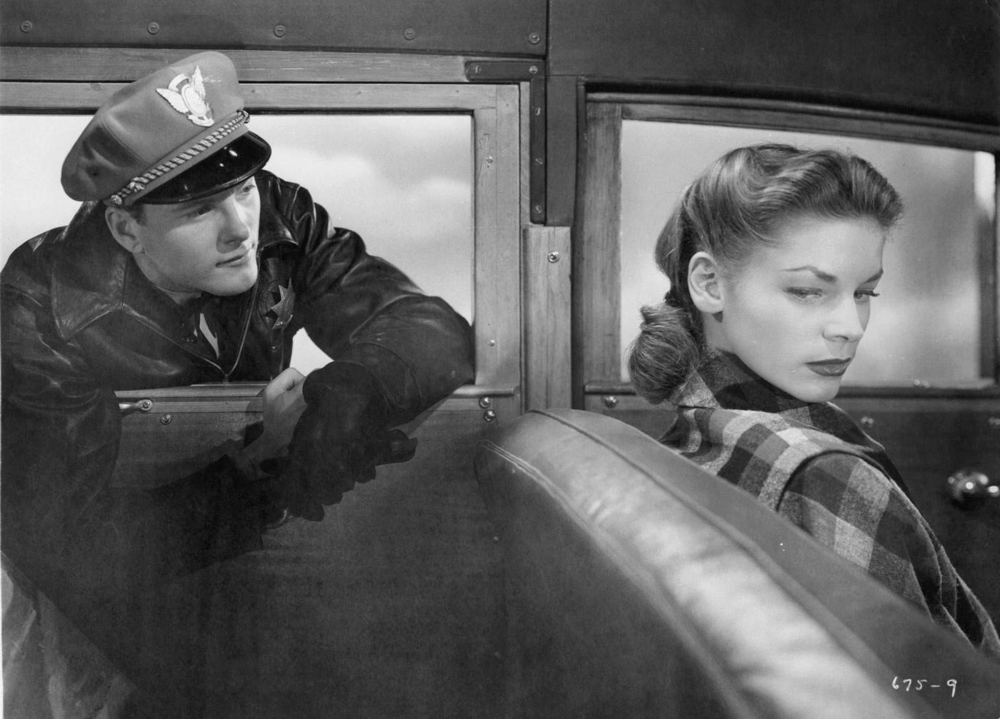 Officer Looks At Lauren Bacall Through Car Window In A Scene From The 1947 Film 'Dark Passage'.