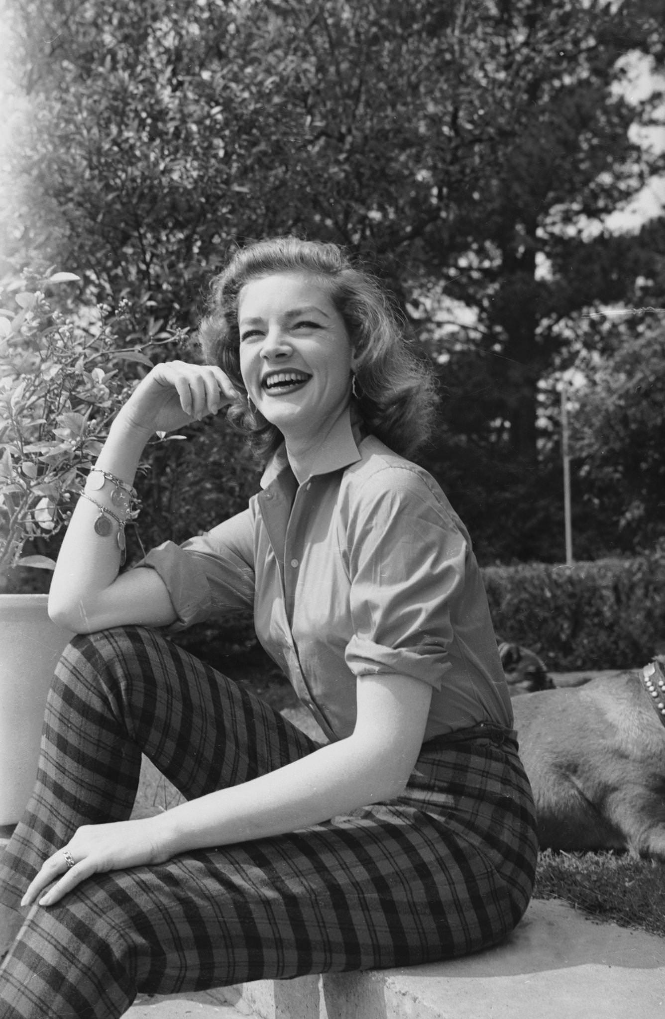 Lauren Bacall Wears Checked Trousers And A Charm Bracelet 1955.