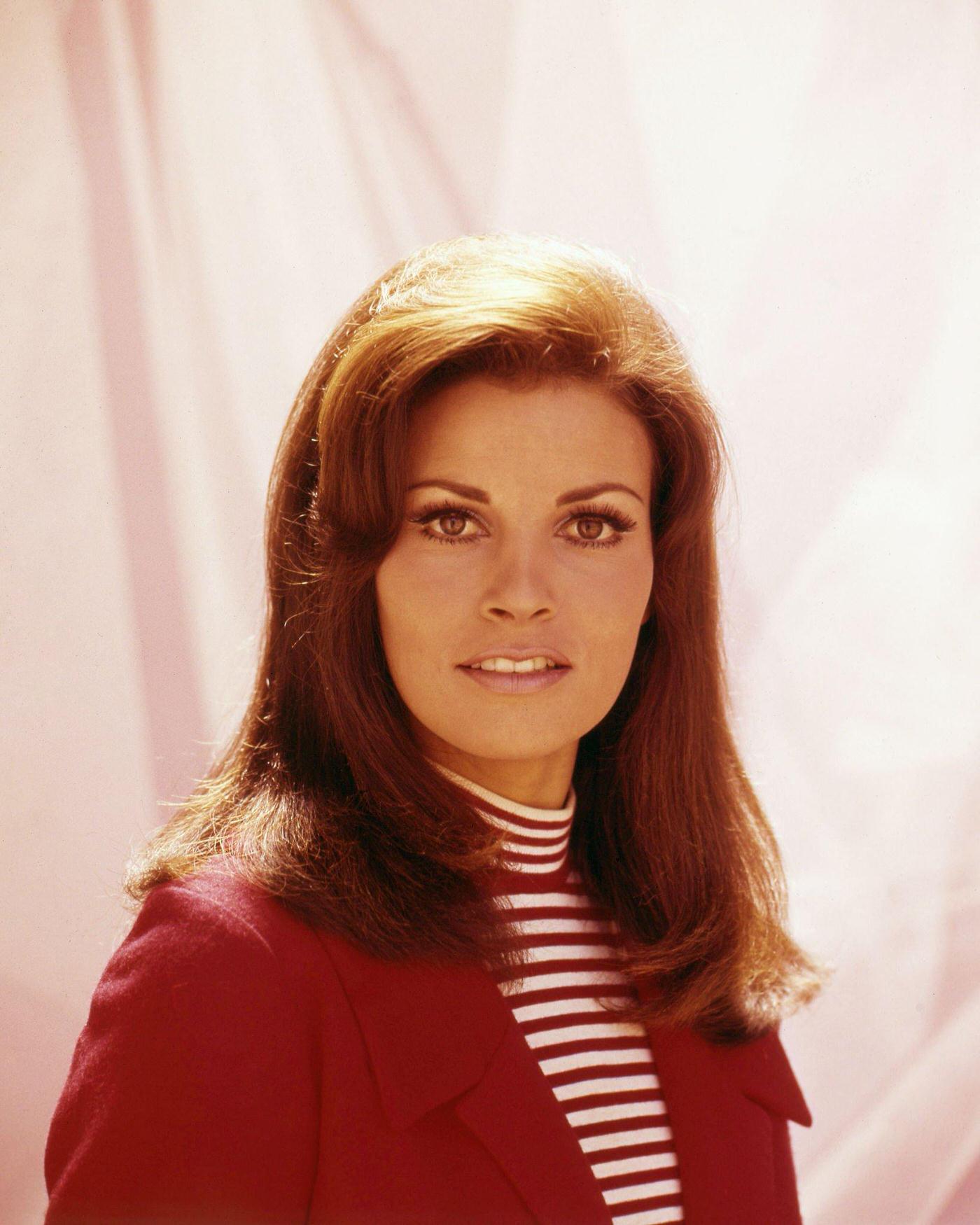Raquel Welch Wearing A Red Jacket Over A Striped Top, 1965.