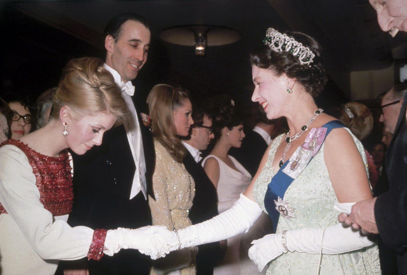 Queen Elizabeth Ii Meets Raquel Welch And Other Actors At A Royal Film Performance In 1966.