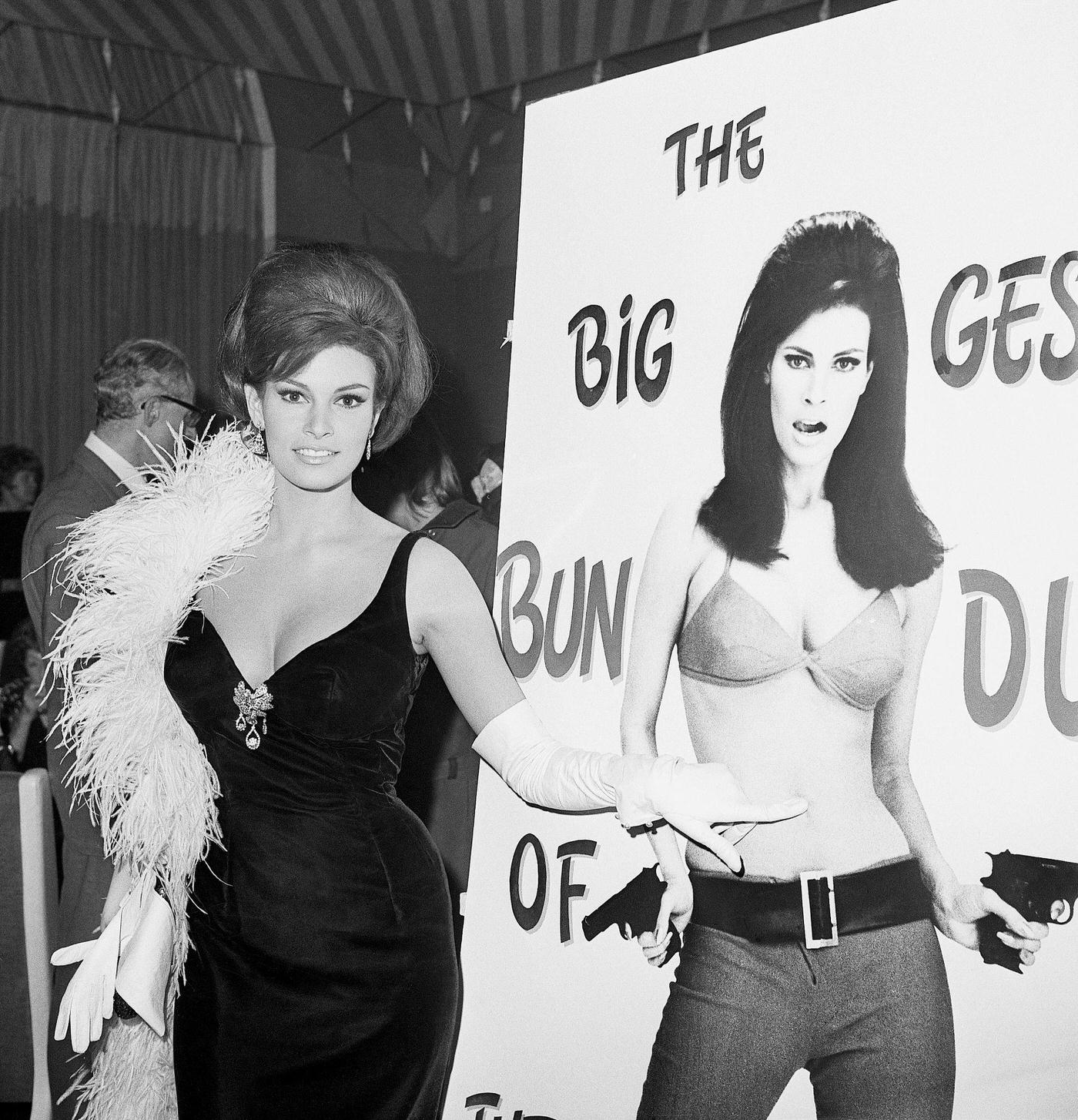 Raquel Welch Playfully Interacts With Her Own Poster For The Film 'The Biggest Bundle Of Them All' At A Party In Rome.