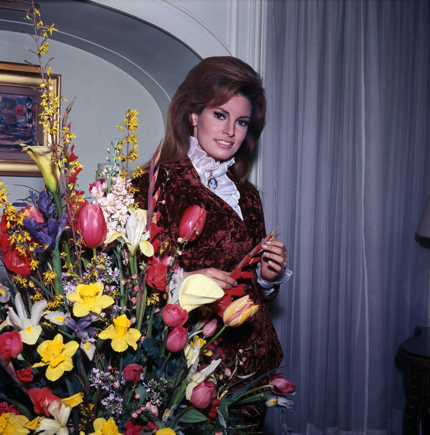 Raquel Welch Posing Behind A Large Bouquet In Her Paris Flat. Paris, 1967.