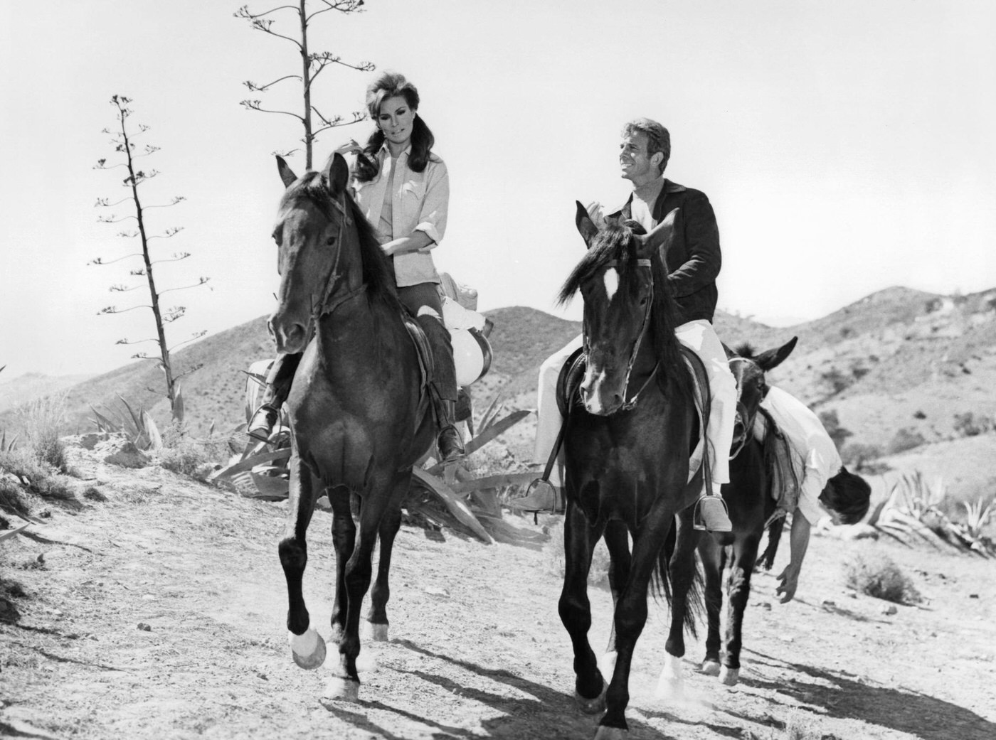 Raquel Welch And Anthony Franciosa Riding Horses In A Scene From The Film 'Fathom,' 1967.