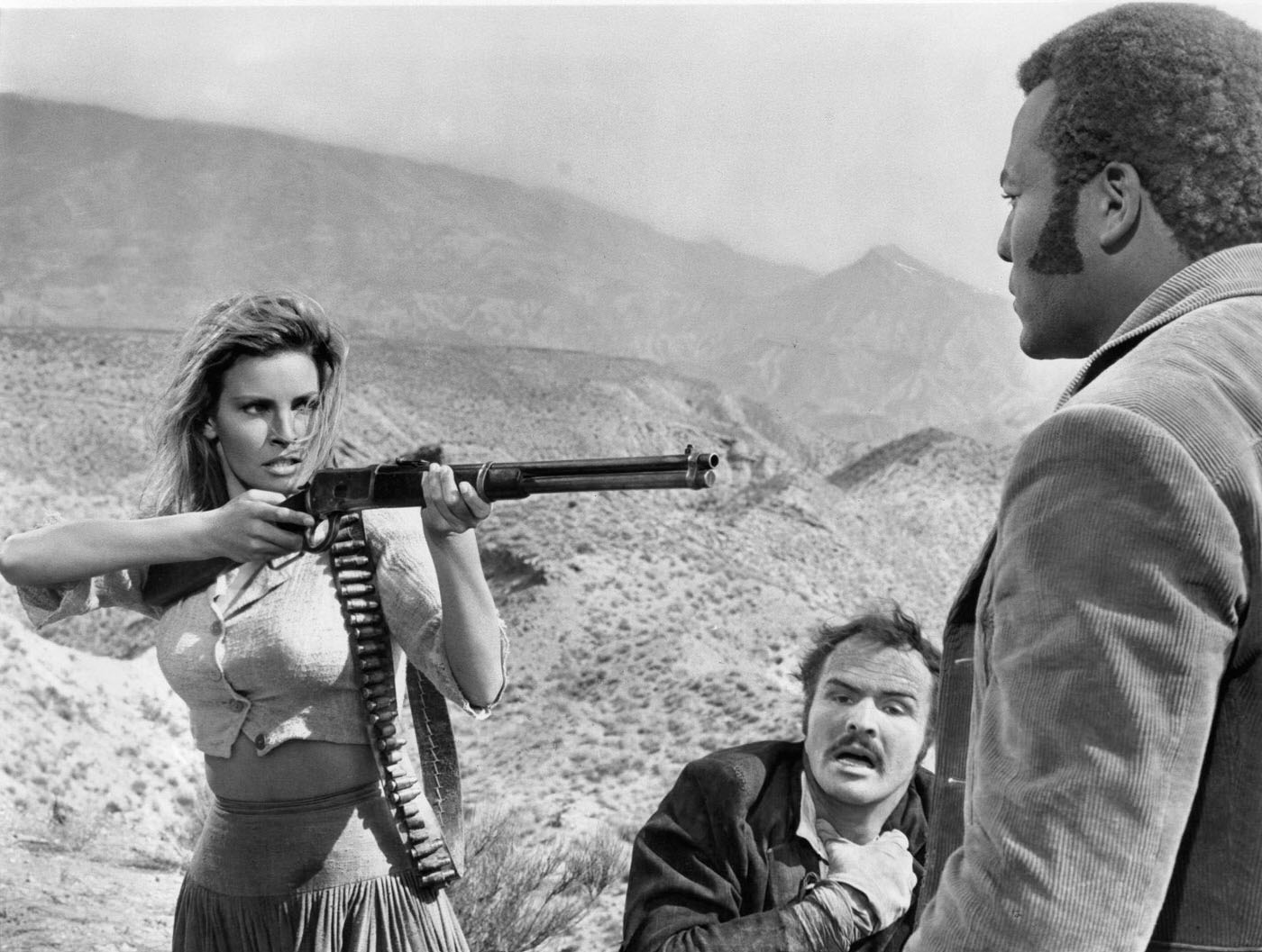 Raquel Welch Pointing A Rifle At Jim Brown In A Scene From The Film &Amp;Quot;100 Rifles,&Amp;Quot; 1969.