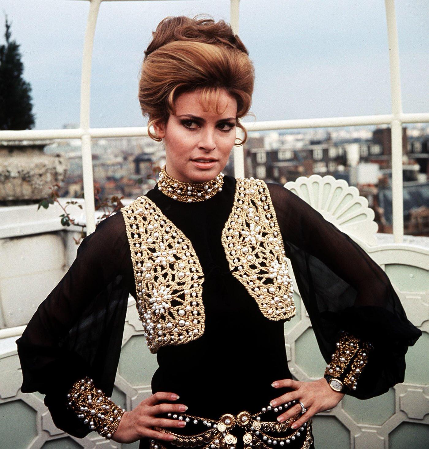 Raquel Welch In A Richly Adorned Black Trouser Suit At The Dorchester Hotel In London, 1969.
