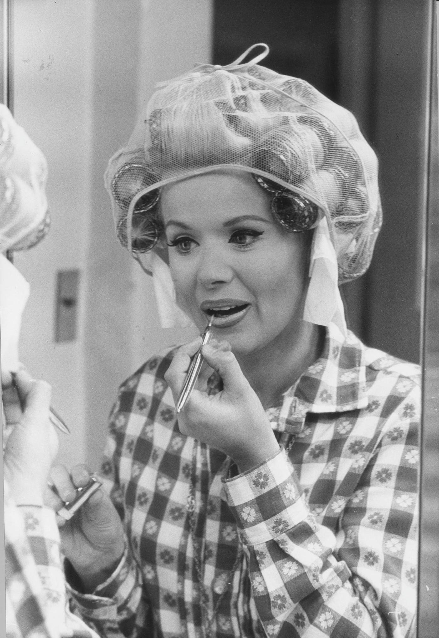 Connie Stevens Applies Lipstick In Front Of A Mirror, Circa 1965