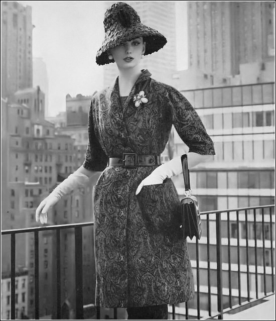Dorothea Mcgowan In Belted Tunic Coat Of Honeyed Brown And Black In A Textured Silk Over A Slim Short-Sleeved Sheath By Georgia Bullock, Black Straw Hat By Sally Victor, 1960