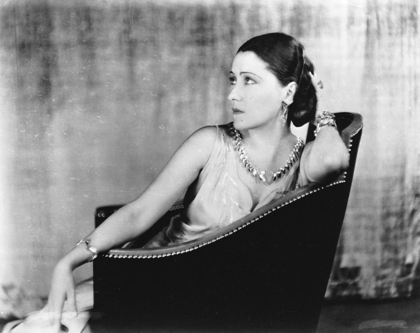 Gloria Swanson Seated In A Studded Armchair, 1931.