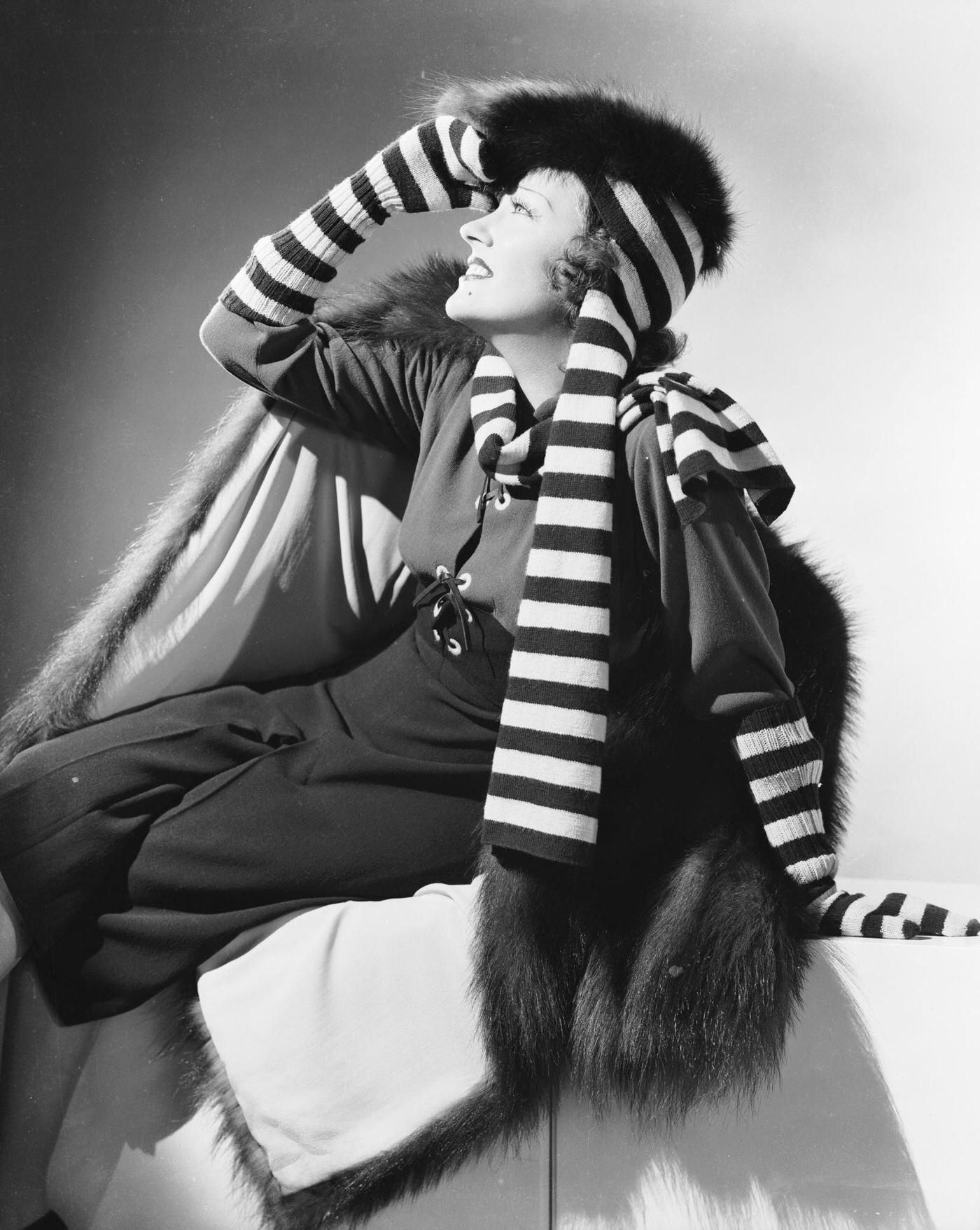 Gloria Swanson Wearing A Fur Hat And Coat With A Striped Scarf And Gloves, Circa 1931.