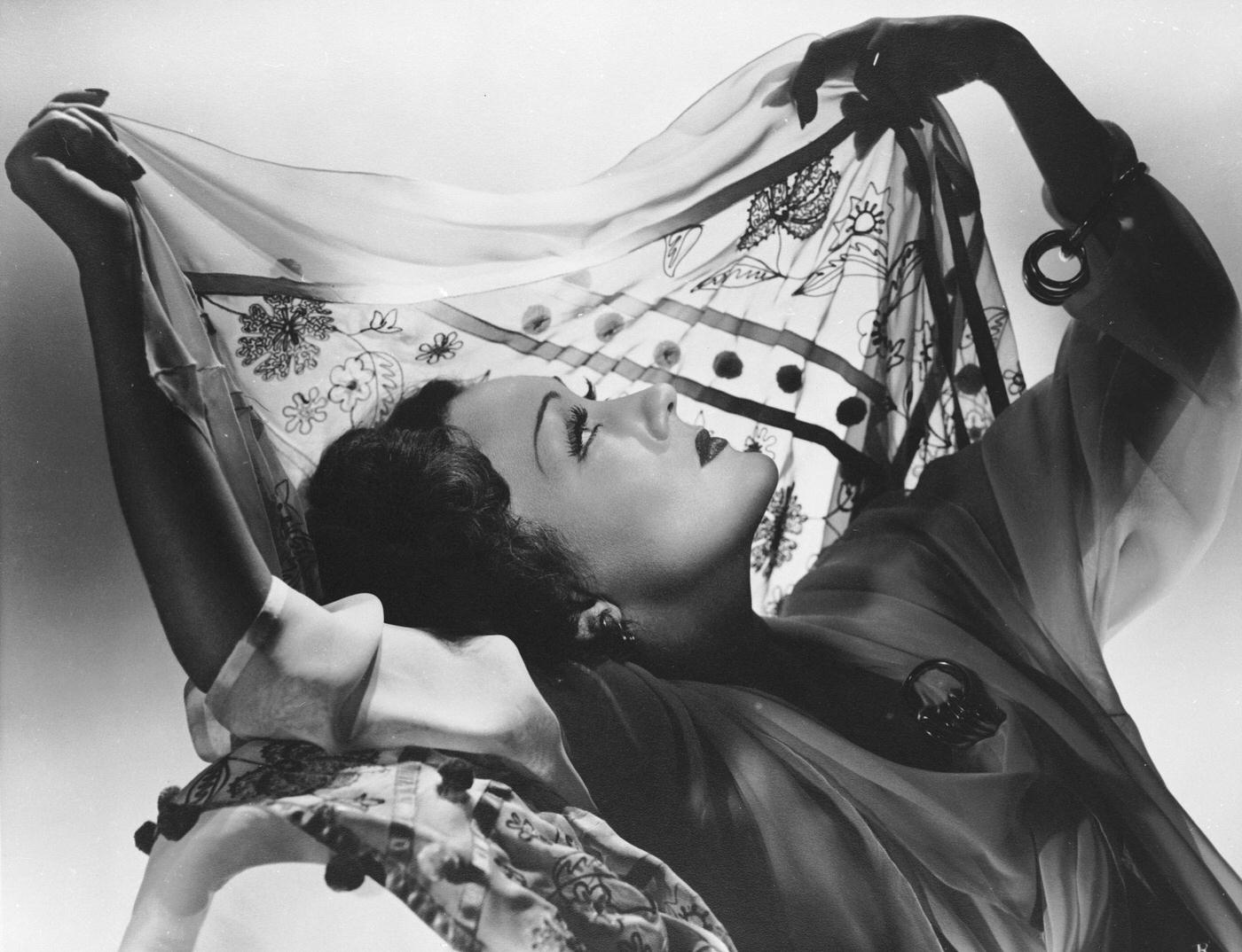 Gloria Swanson Holds A Silk Scarf Up To The Light, Framing Her Profile, Circa 1930.