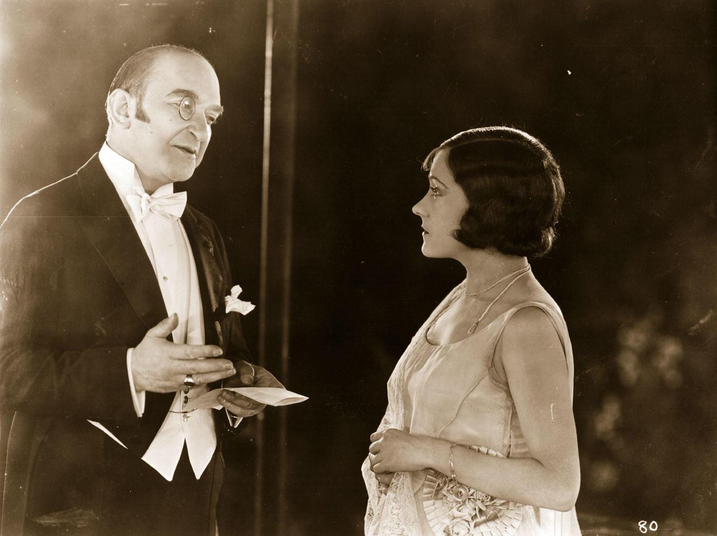 Gloria Swanson Talking To A Monocled Man In A Silent Film, Circa 1918.