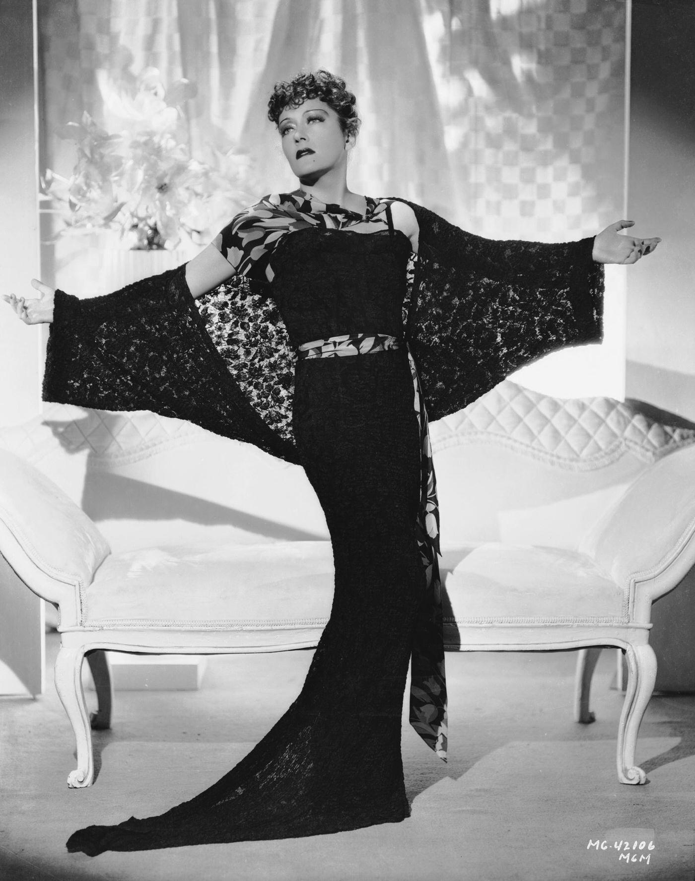 Gloria Swanson Spreads Out Arms To Show Sheer Black Lace Of Her Wrap, 15Th October 1934.