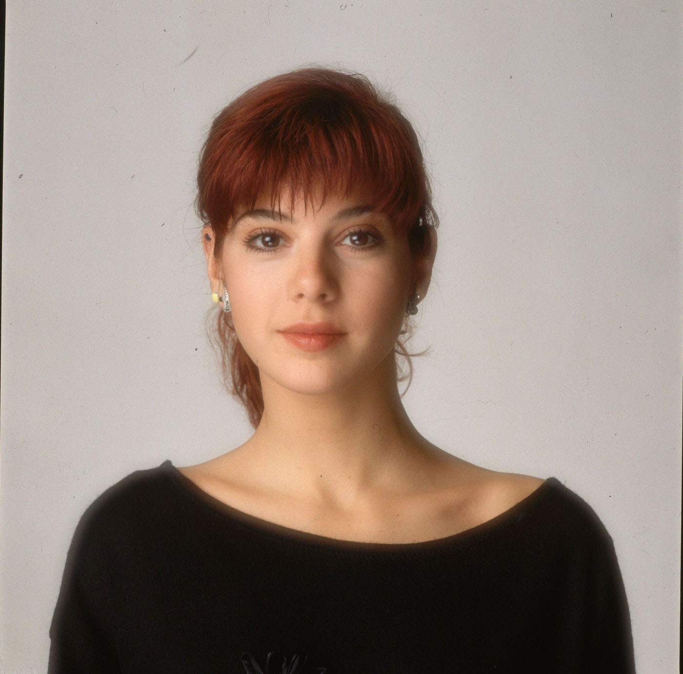 Marisa Tomei Wearing A Black, Boatneck Top Posing In A Studio, 1998.
