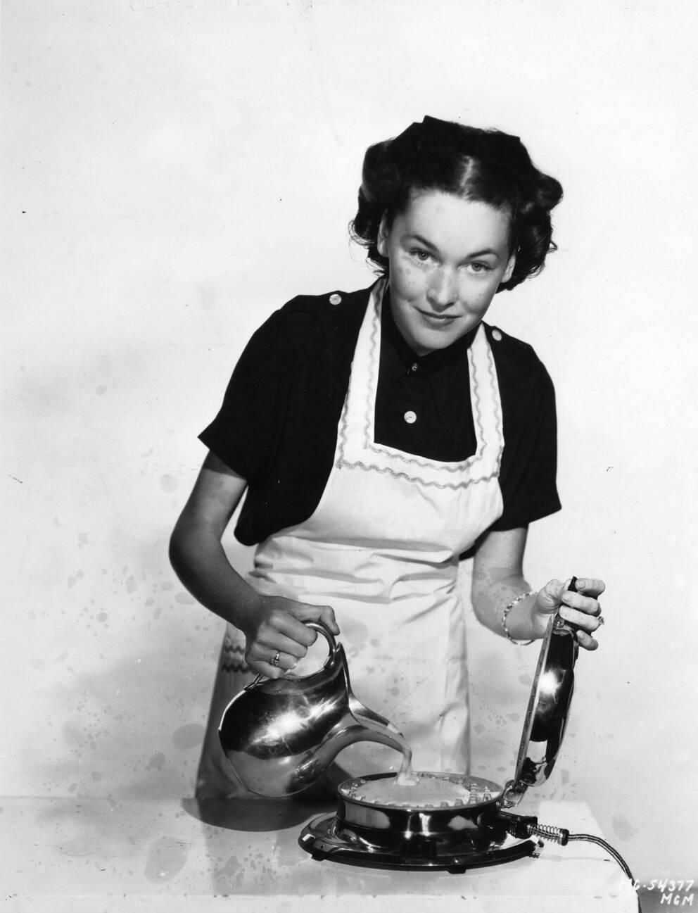 Maureen O'Sullivan Making Waffles With An Electric Wafflemaker.