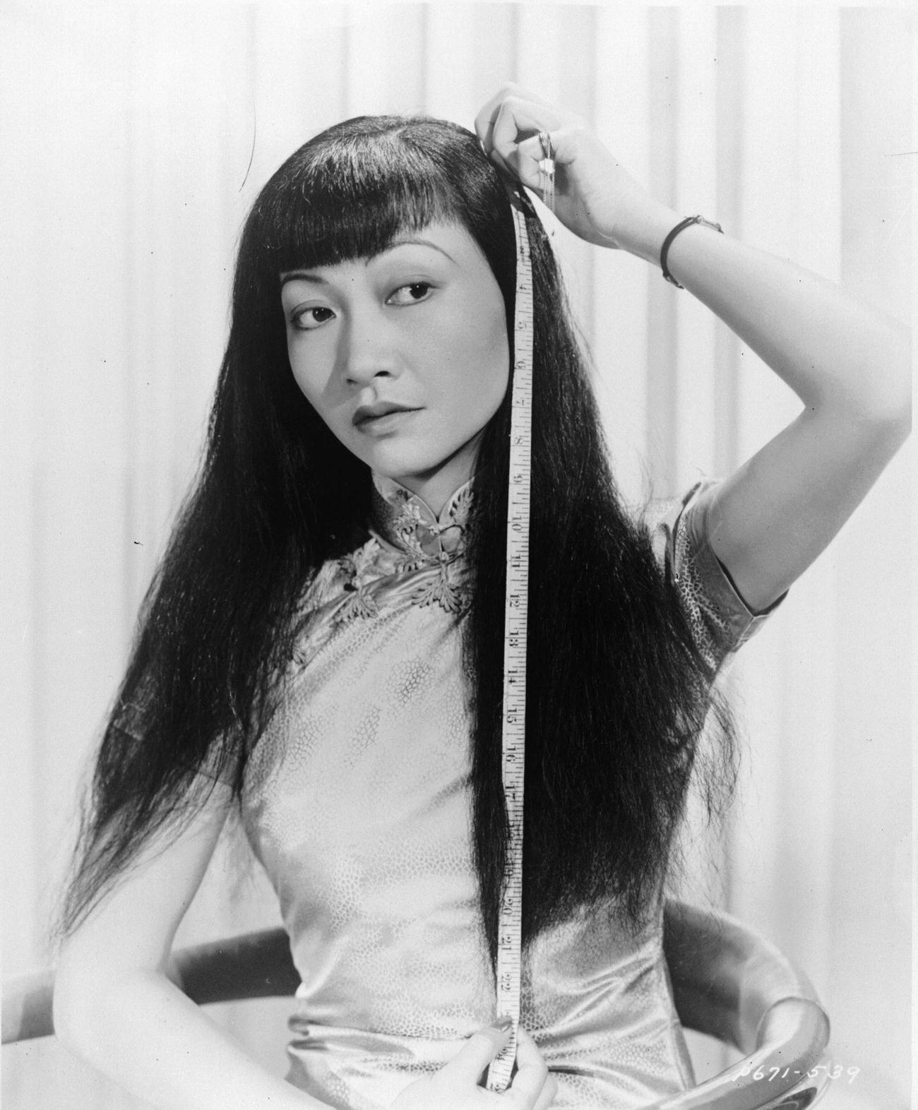 Anna May Wong Measuring Her Hair, Circa 1930.