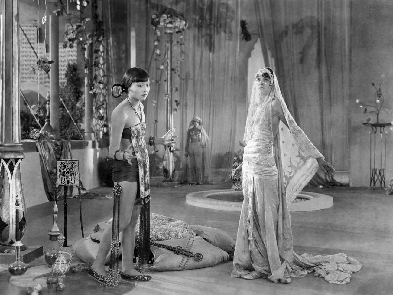 Anna May Wong And Julanne Johnston On-Set Of 'The Thief Of Baghdad', 1924.
