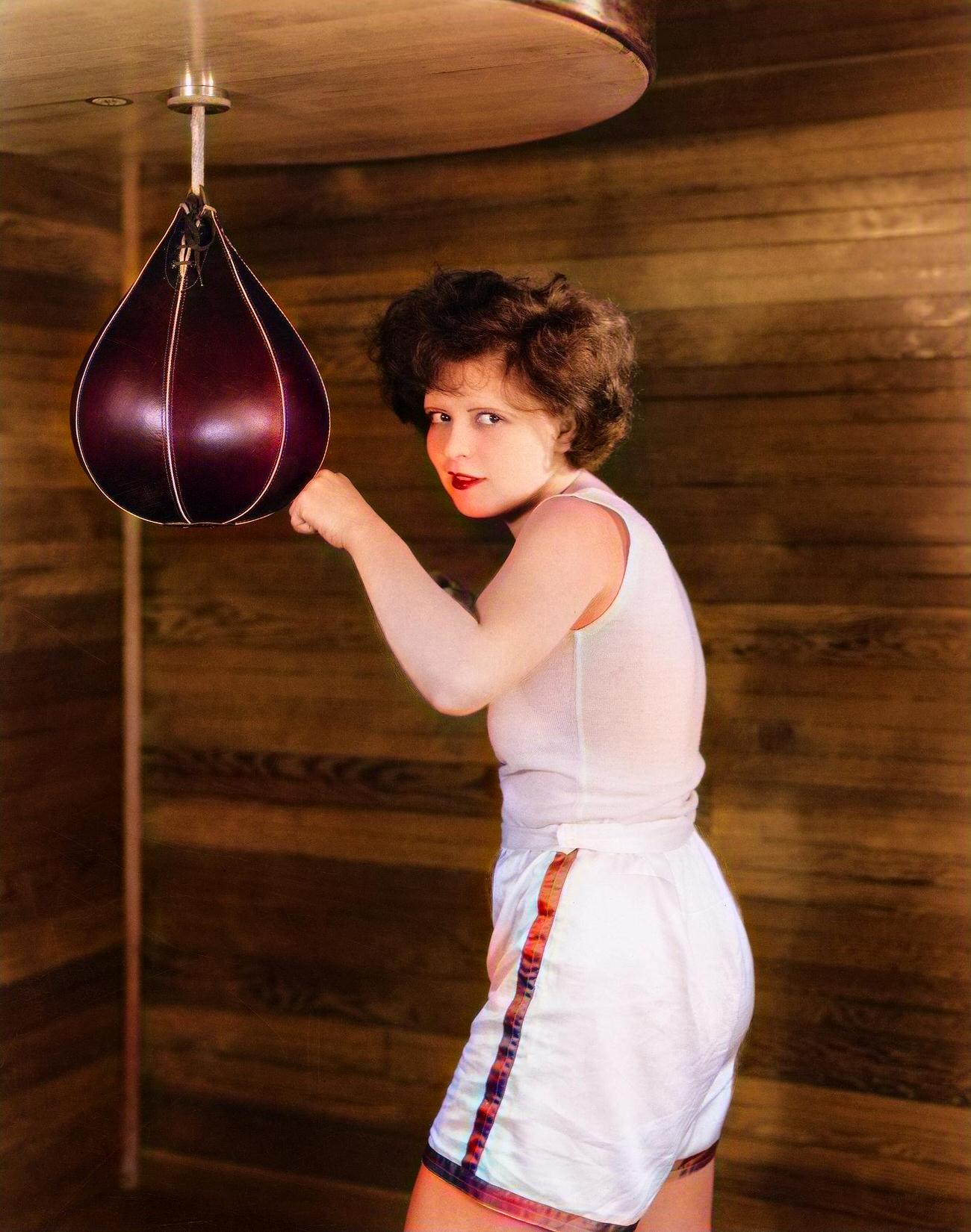 Clara Bow Posing With A Punching Bag In Gym Shorts, Detailing Her Rise And Fall In Hollywood.