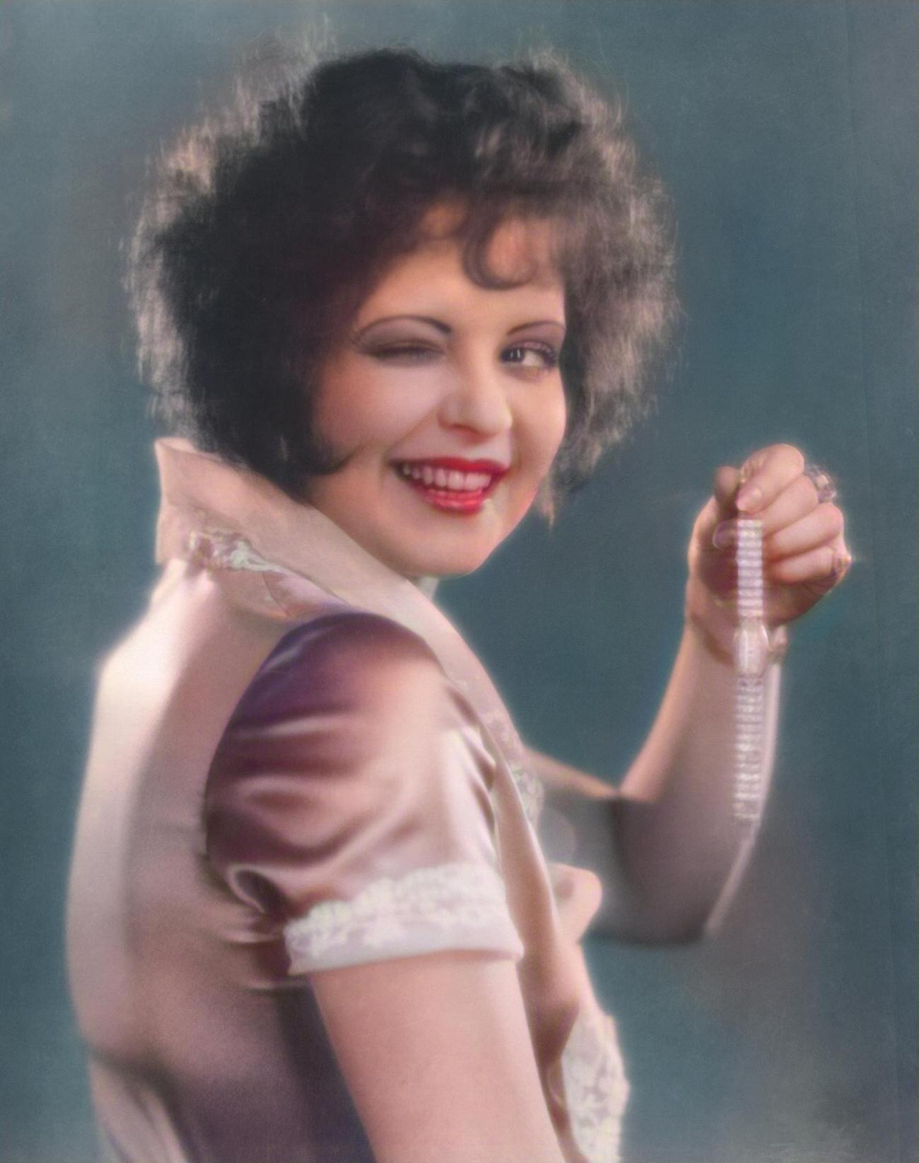 Clara Bow Holding A Gold Diamond-Studded Watch In 'Red Hair', 1927.