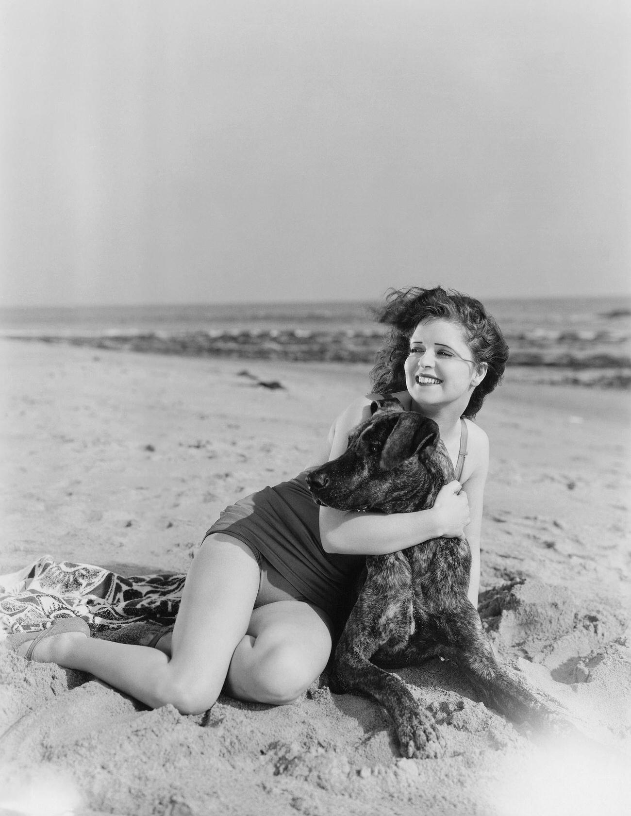 Clara Bow Relaxing On The Beach With A Dog, 1920S