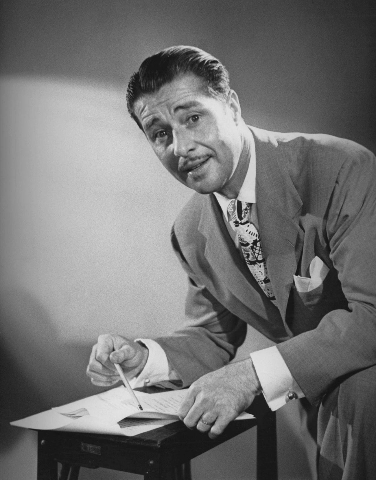 Don Ameche Examining A Script For 'The Frances Langford-Don Ameche Show', Circa 1951.