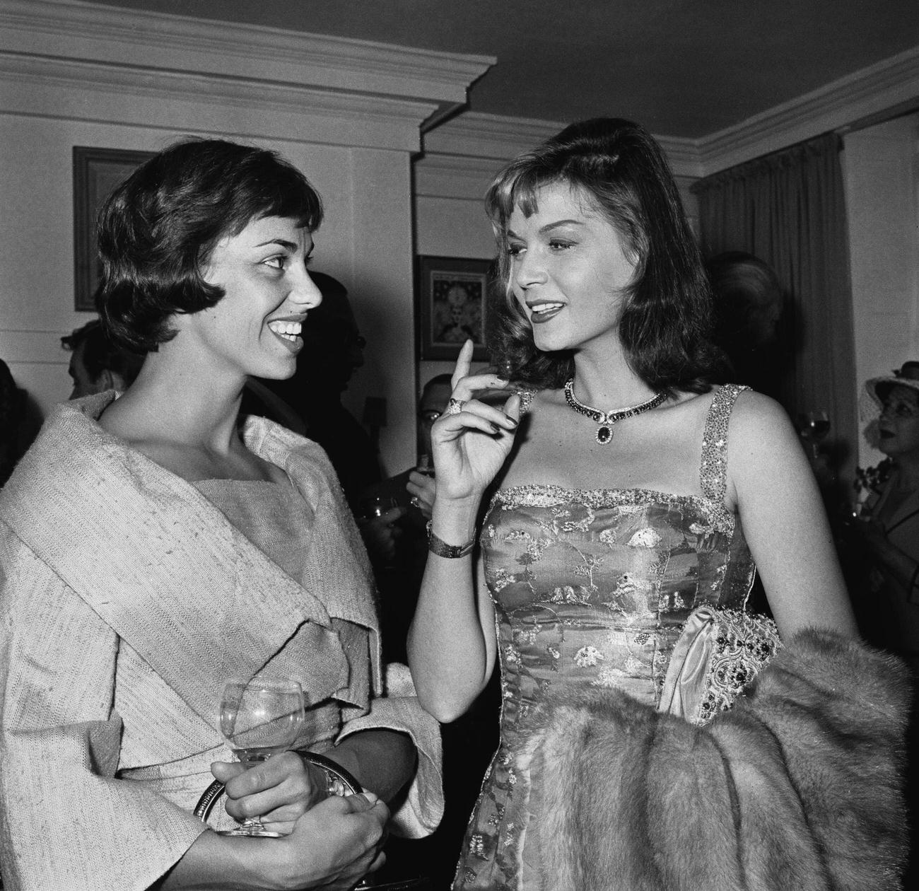 Elizabeth Seal Talking With Eva Bartok At A Party, June 30, 1959.