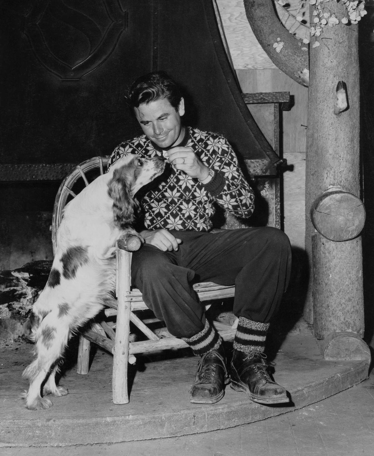 Glenn Ford Giving A Treat To His Dog Hap In Mammoth Lakes, California, 1946.