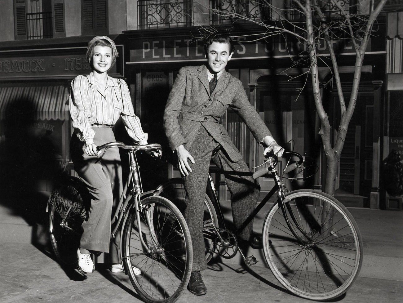 Glenn Ford And Rita Hayworth Riding Bikes In A Scene From &Amp;Quot;It Happened In Paris&Amp;Quot;, 1940.