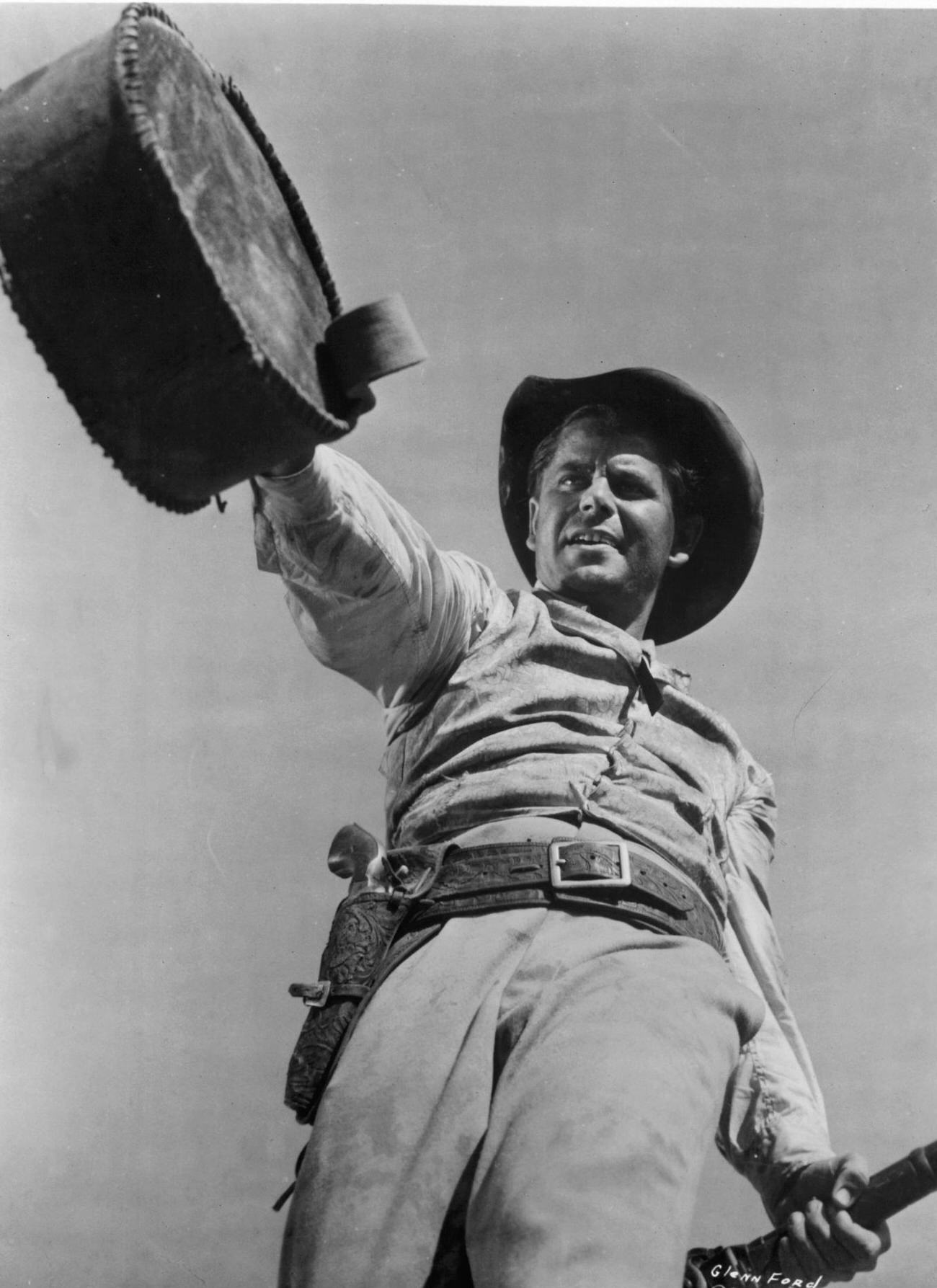 Glenn Ford Raising A Water Jug In 'Lust For Gold', 1949.