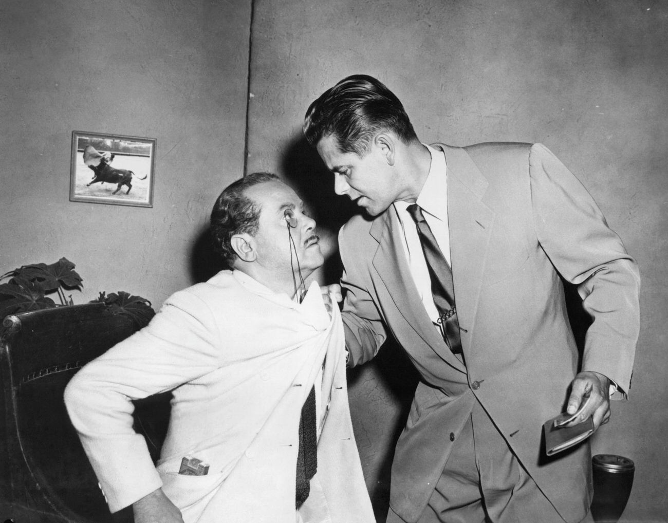 Glenn Ford Grabs A Man By The Collar In 'Affair In Trinidad', 1952.