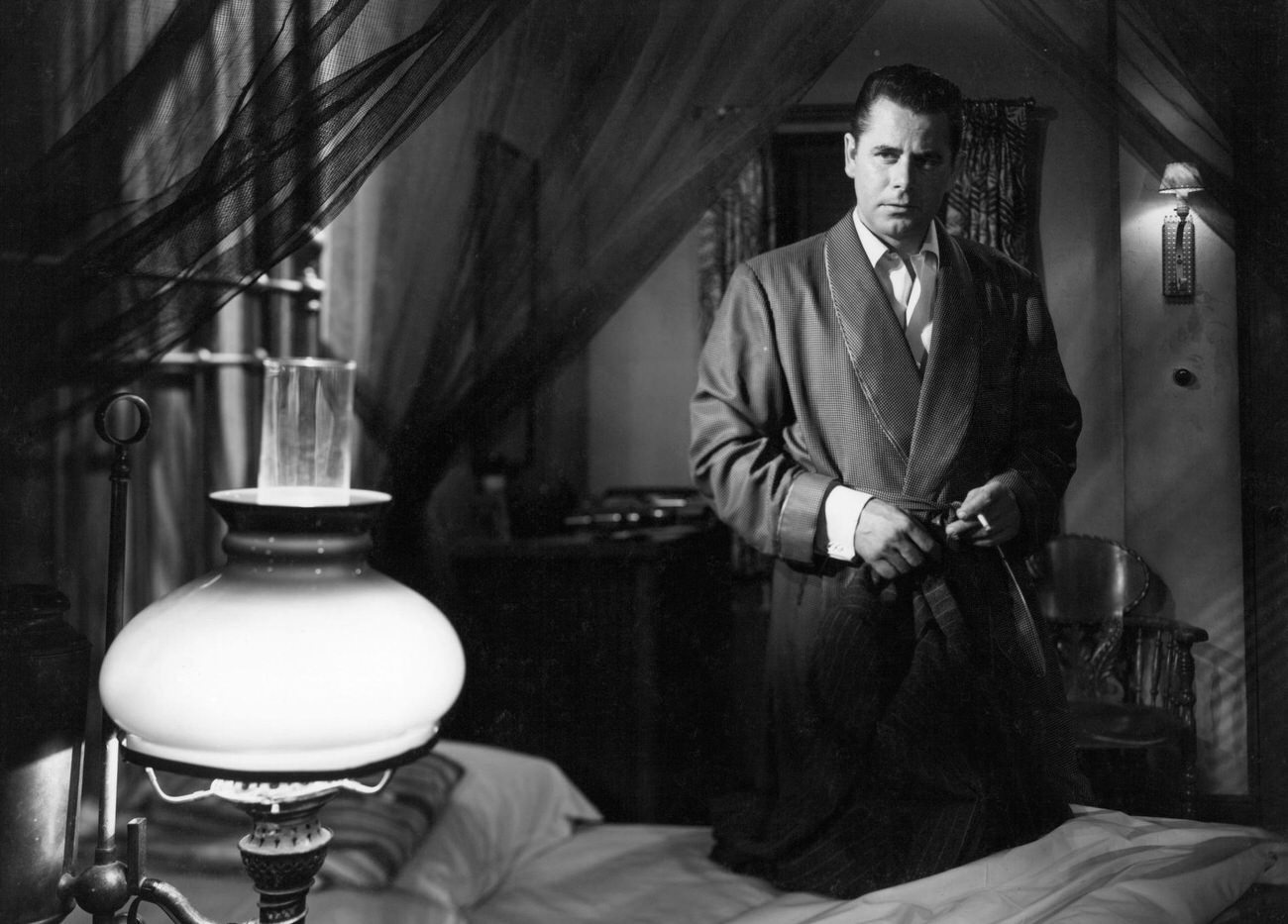 Glenn Ford In A Robe Holding A Cigarette In 'Affair In Trinidad', 1952.