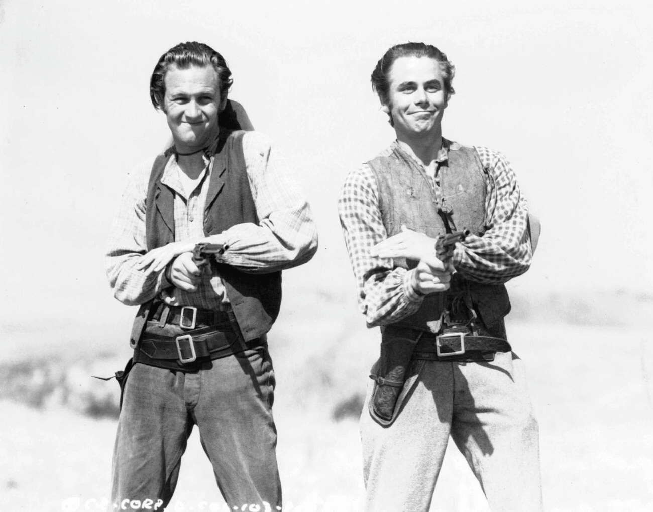 William Holden And Glenn Ford Firing Pistols In The Film 'Texas', 1941.